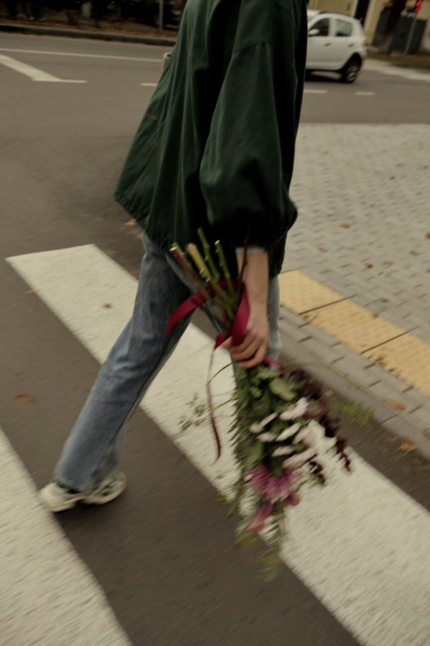 Crossing the street with the bouquet